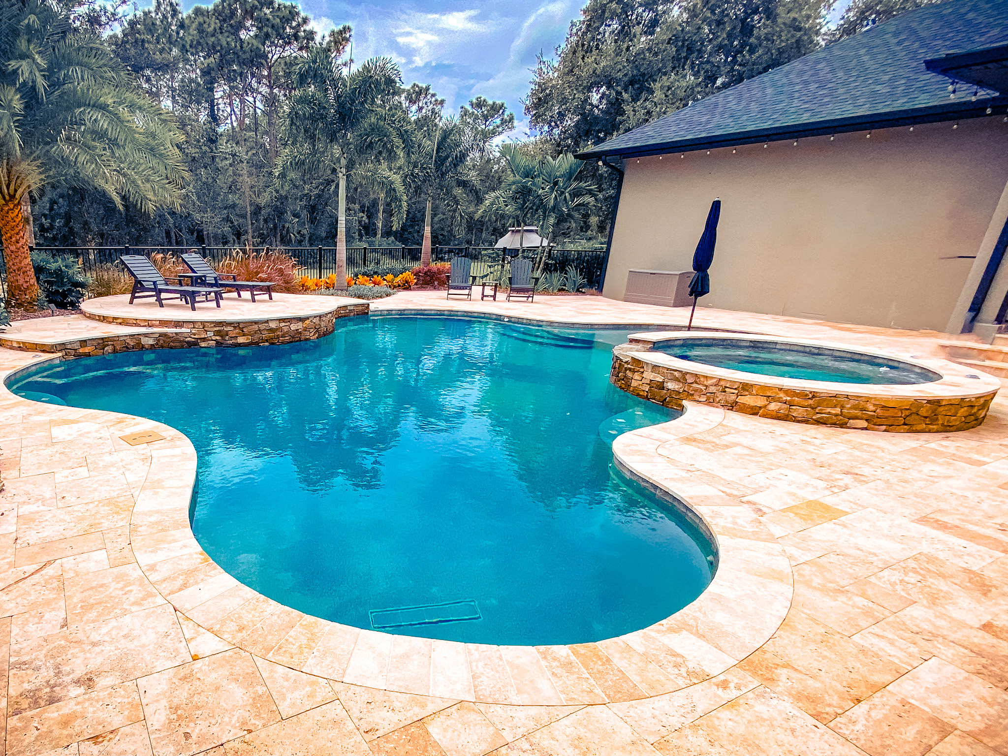 Luxurious outdoor poolside seating area with custom-designed pools by Yellowfin Pool Creations, Central Florida